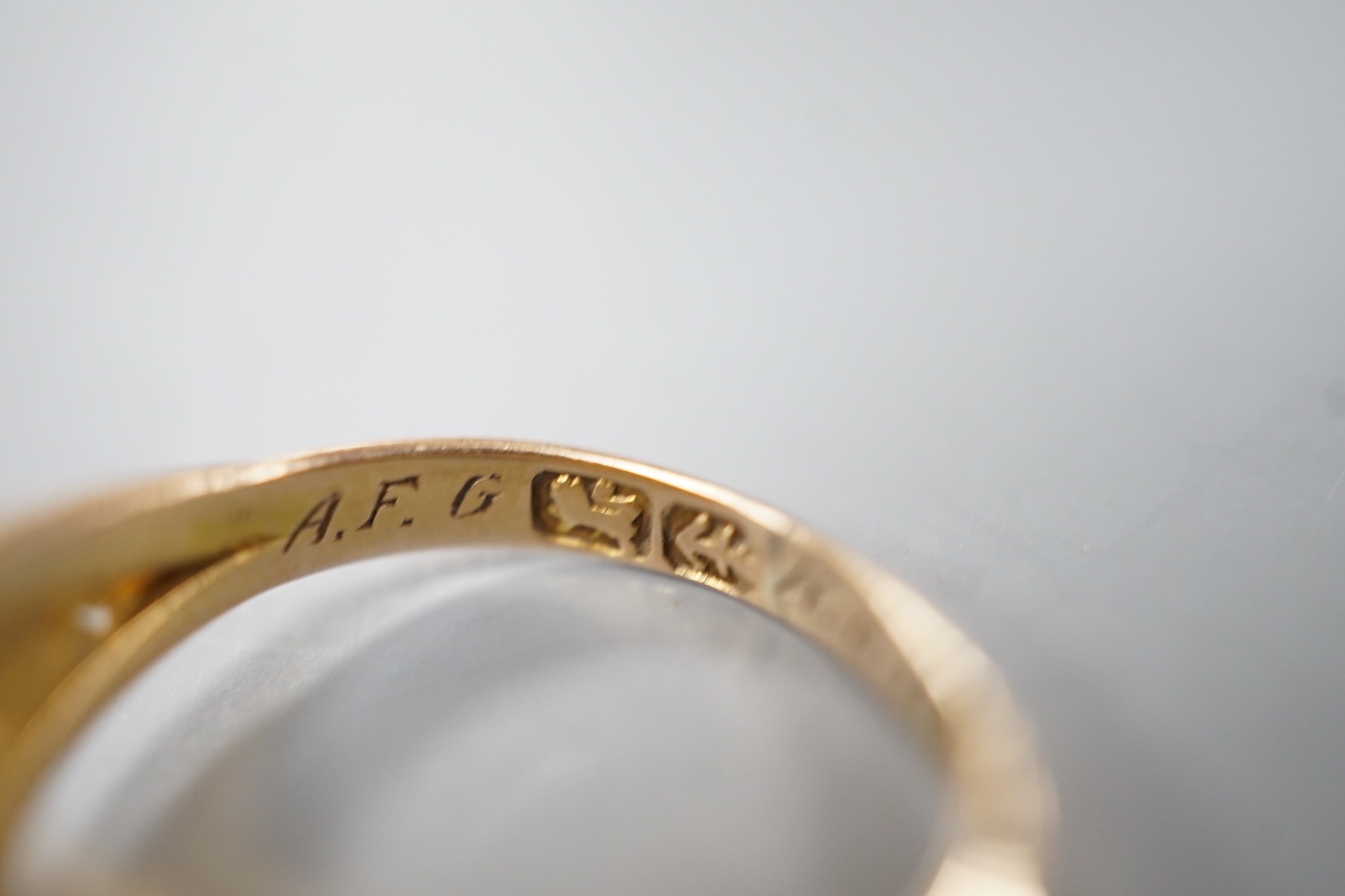 A late Victorian gold, emerald and split pearl cluster set ring, with later engraved inscription, size N, gross weight 2.9 grams.